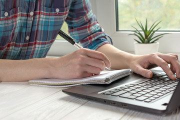Education concept. Online studying from home office with black laptop
