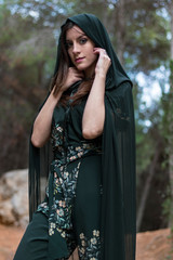 Woman in the middle of the forest posing in a robe