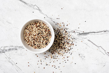 Mix of white, red and black quinoa seeds in bowl