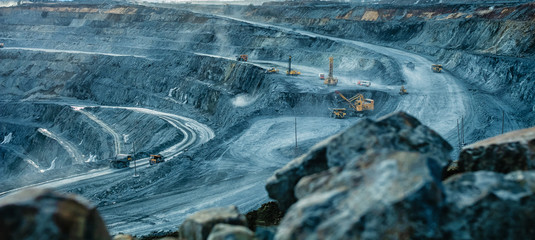 Work of trucks and the excavator in an open pit - obrazy, fototapety, plakaty