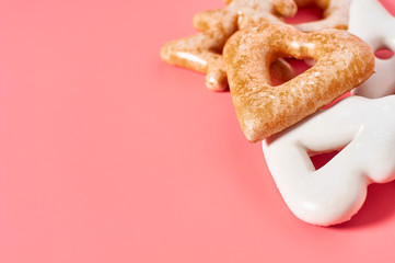 Heap of various festive christmas cookie on pink background. New year celebration concept
