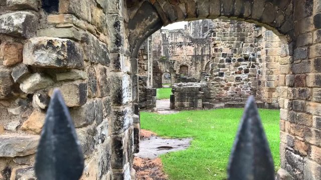 Sliding shot from behind the gates of Kirkstall Abbey in Leeds, UK.