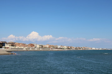 Fototapeta premium view of beach beautiful view of buildings and blue sea water near rome Italy 
