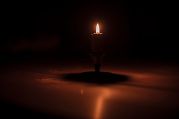 burning candle in the dark