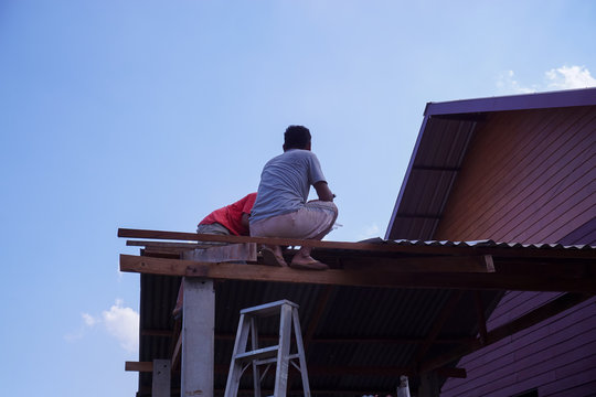 Two technicians are fixing the roof.