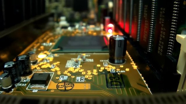 The camera slowly moves over the printed circuit board with main processor, on which seen the entire internal structure of the microchip. A blinking LED indicates data miscalculation. Macro. Closeup. 