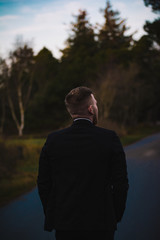 Guy walking down the street in a suit.