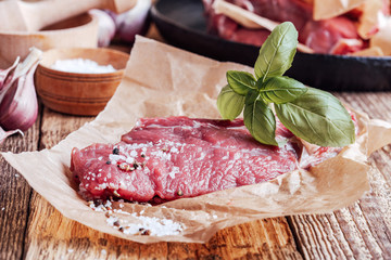 Raw organic beef meat steak  with herbs and spices