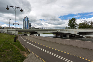 Fototapeta na wymiar MINSK, BELARUS - MAY 22, 2020: Panorama the central part of the city of Minsk Nemiga. Bicycle path and river swiss