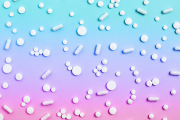 medicine concept. a pattern of white and red pills and capsules on a gradient background. flat lay, top view