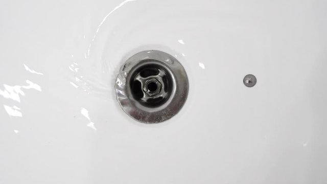 Water drains into the sink in bathroom.