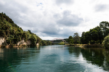 Fototapeta na wymiar the calm water of Waikato River passing by East Taupo Arterial bridge