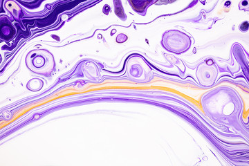 Fluid art texture. Backdrop with abstract swirling paint effect. Liquid acrylic picture with chaotic mixed paints. Can be used for posters or wallpapers. Purple, white and golden overflowing colors