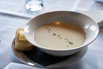 cream of mushroom soup with buttered bread on the side