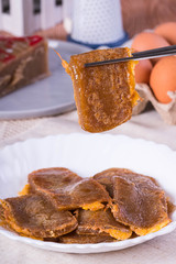 Chinese new year's cake is a food prepared from glutinous rice flour and consumed in Chinese cuisine also known as tikoy or nian gao; in the Philippines they cover it with egg