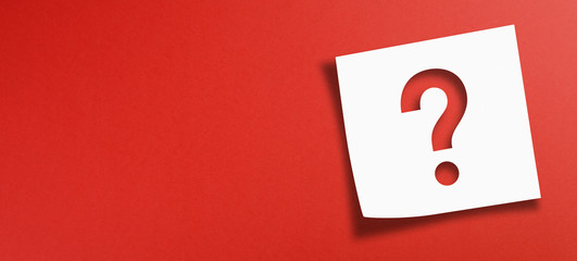 Note paper with question mark on panoramic red background	