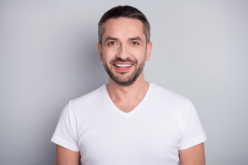 Close-up portrait of his he nice attractive content cheerful cheery bearded guy sportsman wearing tshirt isolated over light grey pastel color background