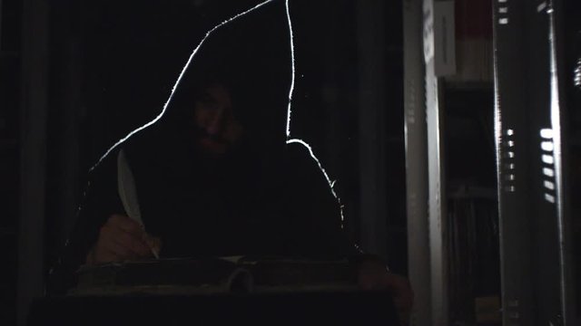 Monk is making notes with feather