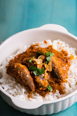 tomato sardines with crab fat on topped of rice or also known as aligue rice in the Philippines