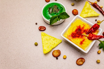 Hummus, healthy vegan (vegetarian) food. Assorted three types: classic, mint and beetroot. Edamame dry beans, pieces of pita bread, spices