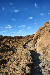 The way to the top of the Teide volcano. Stone path in the mountains to the top.