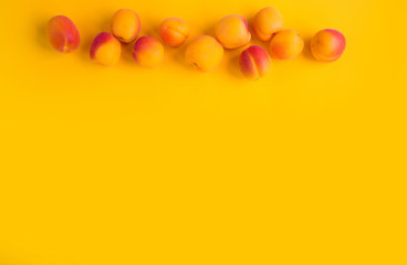 Ripe apricots fruit yellow background