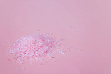 Himalayan salt on a pink background close-up. Pink bath salt