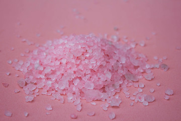 Himalayan salt on a pink background close-up. Pink bath salt