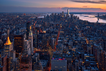 New York City aerial view of the skyscrapers of Manhattan at twilight. The view includes Lower Manhattan, Flatiron District, Midtown and the World Trade Center. NY, USA