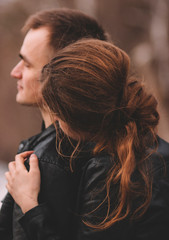 lovers boyfriend and girlfriend gently hug and look into the distance