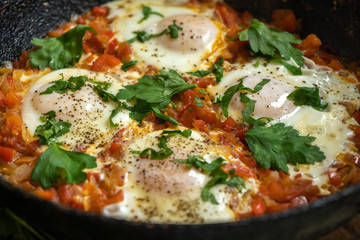 Scrambled eggs shakshuka on a hot pan