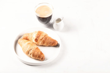 Croissants and coffee in the style of minimalism.