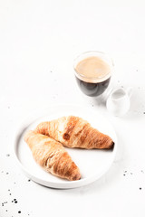 Croissants and coffee in the style of minimalism.
