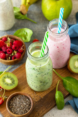 The concept of a healthy diet. Detox smoothies mix. Green smoothies vegetable and fruit smoothies on a stone concrete worktop.