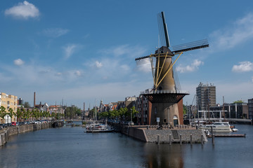 Fototapeta na wymiar The historic Delfshaven district with windmill in Rotterdam, The Netherlands. South Holland region. Summer sunny day