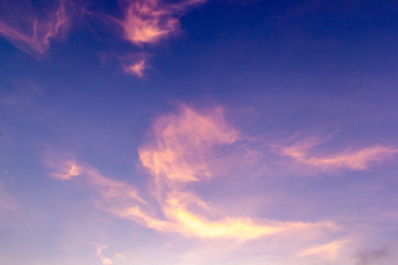 Colorful sunset sky above clouds with dramatic light in twilight time. Beautiful sunset background