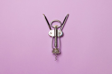 metal corkscrew on purple background