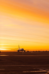 Fototapeta premium Silhouette of a plane in the airport on the dawn