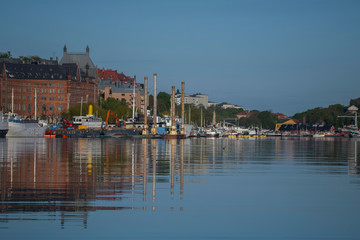 Fototapeta premium Old brewery and boats at the waterfront at the bay Riddarfjärden at the district Södermalm in Stockholm a spring sunny morning.