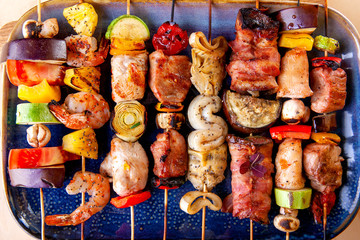 seafood meat bacon grilled vegetables on wooden skewers