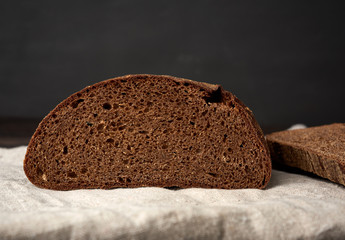 sliced oval rye bread bread on a wooden board