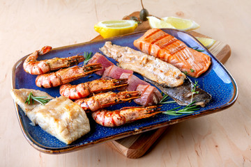 assorted different types of fish and shrimp on a plate