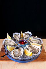 oysters with lemon and ice sauce in a plate