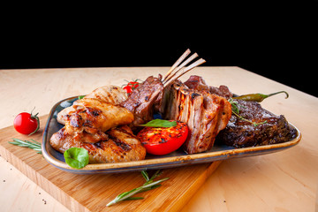 different types of meat with tomatoes and zucchini in a plate