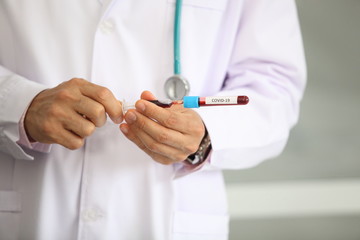 Doctor holding sample covid-19 vaccine vial with medication, closeup.