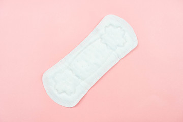 Top view white sanitary napkin isolated on pink background. Woman hygiene, Concept of critical days, menstruation,health care