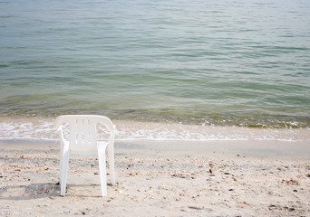 Picture of two chairs standing on seaside beach near calm sea