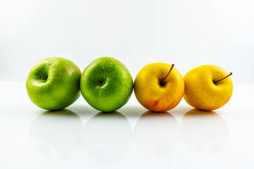 Yellow and green apples isolated on white background