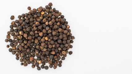 Close-up of a bunch of black pepper isolated on white background selective focus, copy space