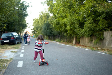 little girl riding a scooter